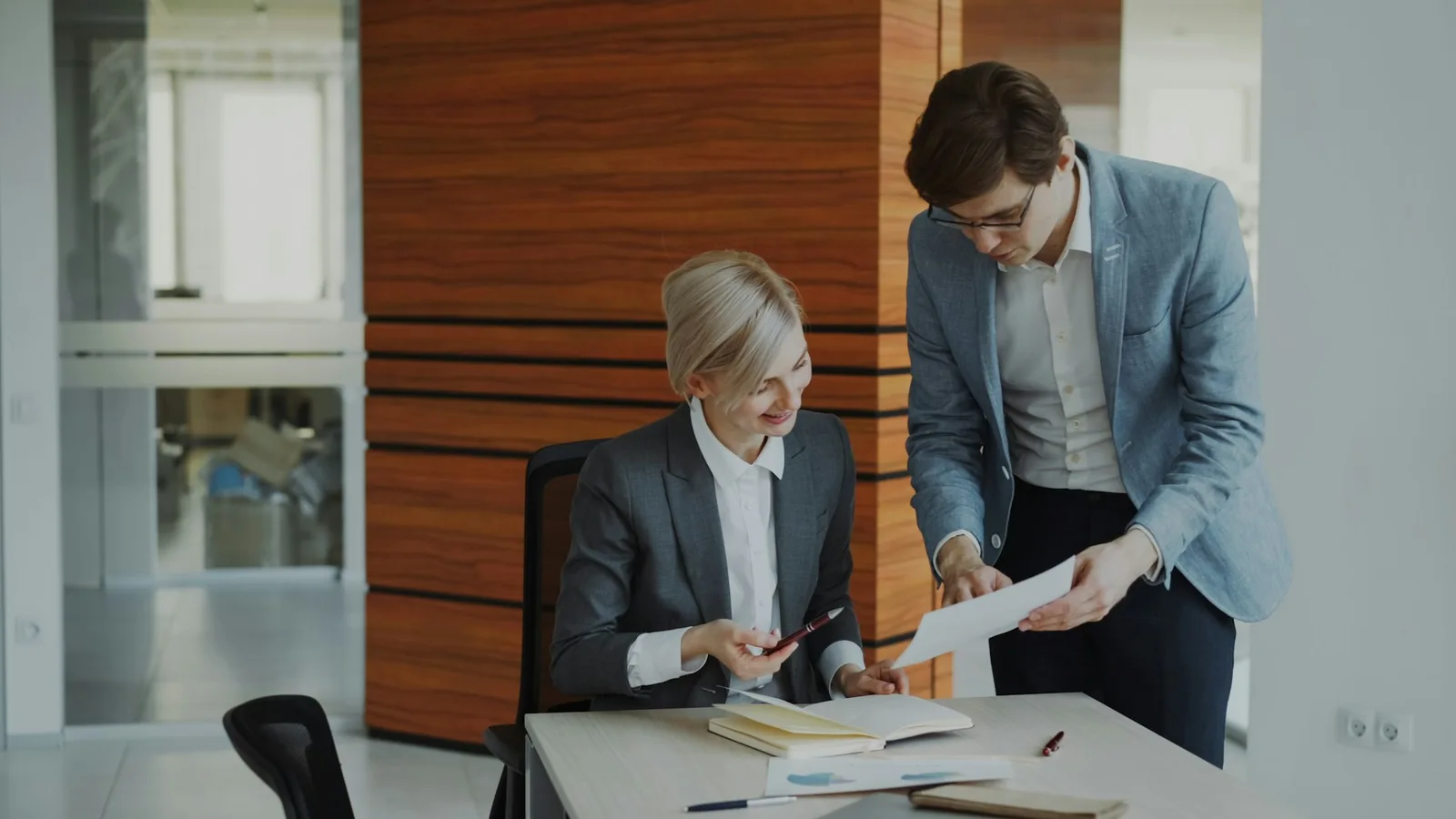 Illustrative colleagues reviewing business documents